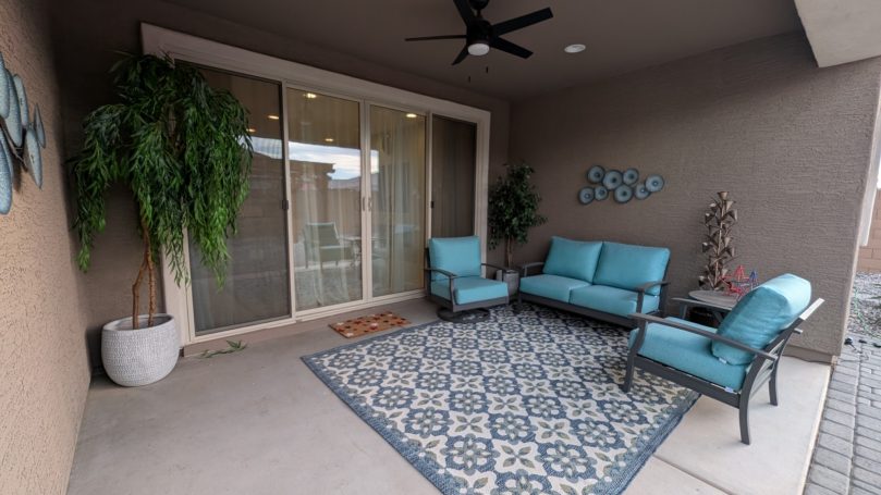 Covered outdoor patio with comfortable seating at Desert Willow Memory Care.