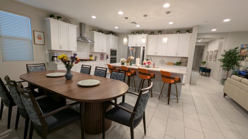 Bright open-concept dining room and modern kitchen at Desert Willow Memory Care with comfortable seating and spacious layout.